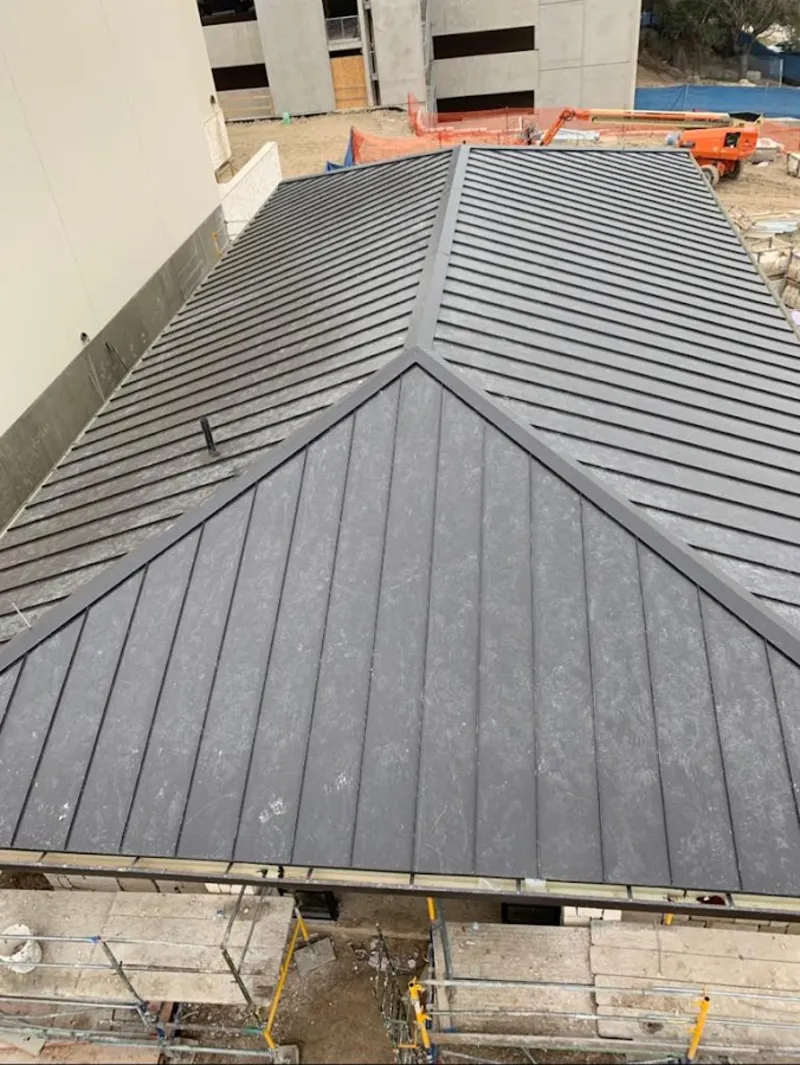 Commercial metal roof construction with crane equipment in West Cocalico